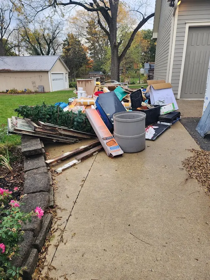Dumpster being loaded with debris for Commercial Dumpster Rental in Olmsted Falls